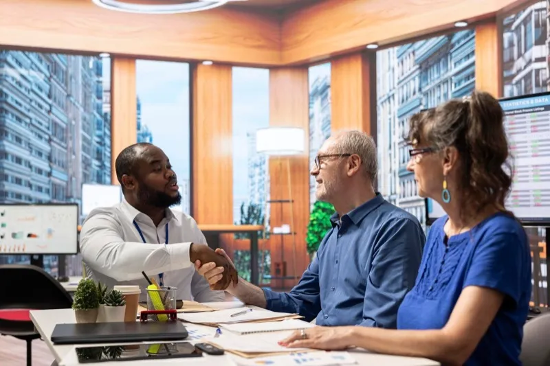 Healthcare professional shaking hands with a facility administrator, establishing a partnership