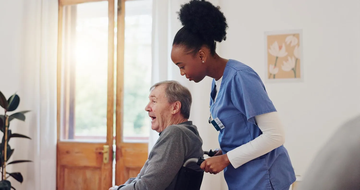 Caregiver providing compassionate support to a senior patient in a nursing home setting